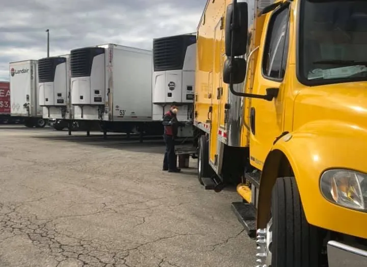 Refrigerated trailers and service trucks in the maintenance yard
