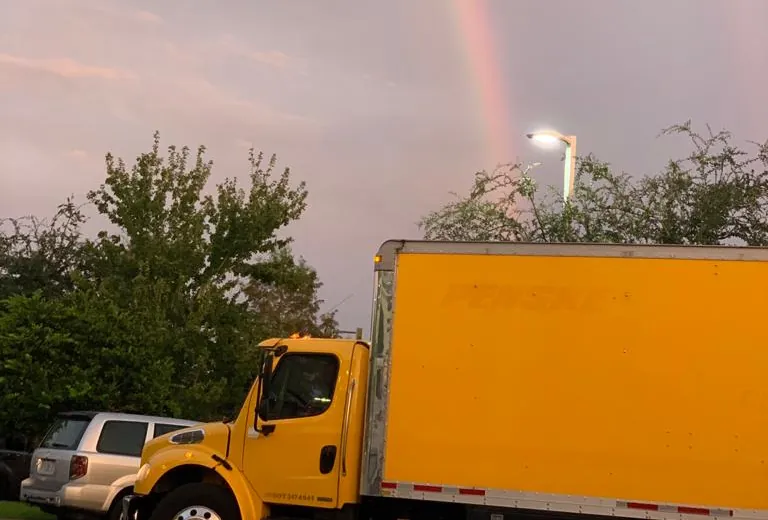 JJ Transport Refrigeration refrigerated box truck under a rainbow