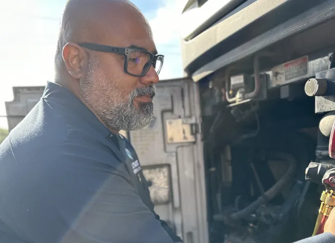 Technician inspecting a transport refrigeration unit during training